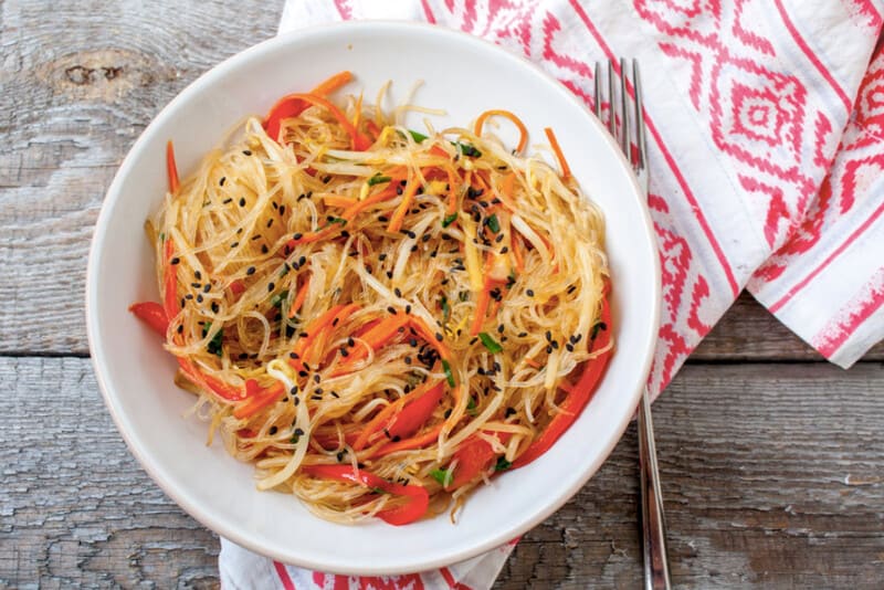 Vietnamese vermicelli salad in a white bowl on the table.