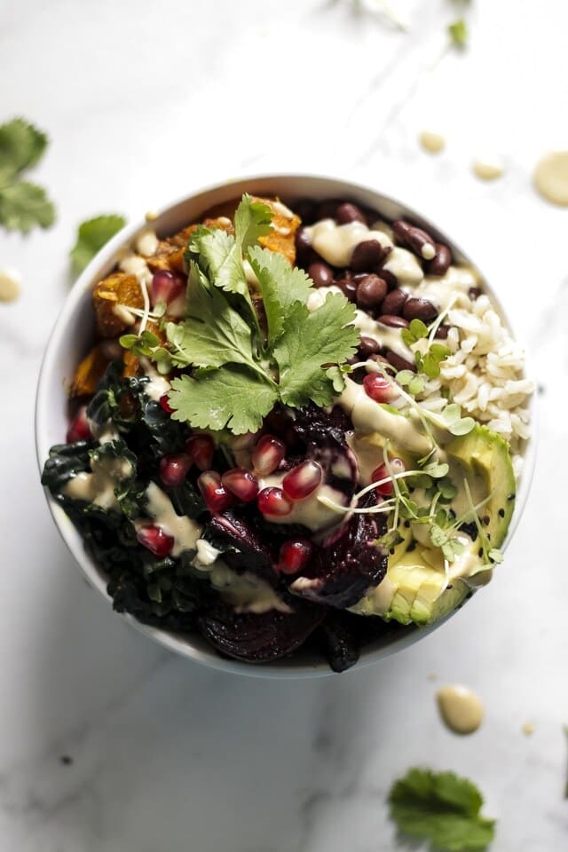 Buddha bowl with beans, avocado, pomegranate, and cilantro.