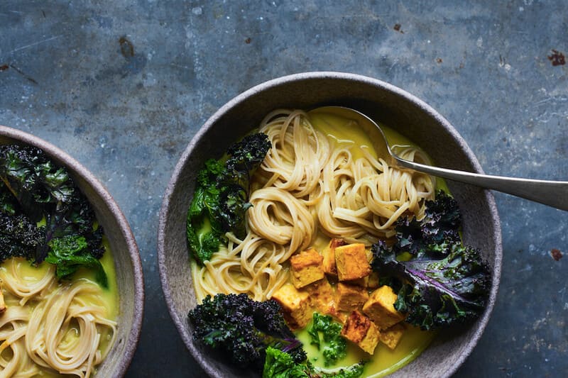 Grey bowl with miso ramen, kale and tempeh.