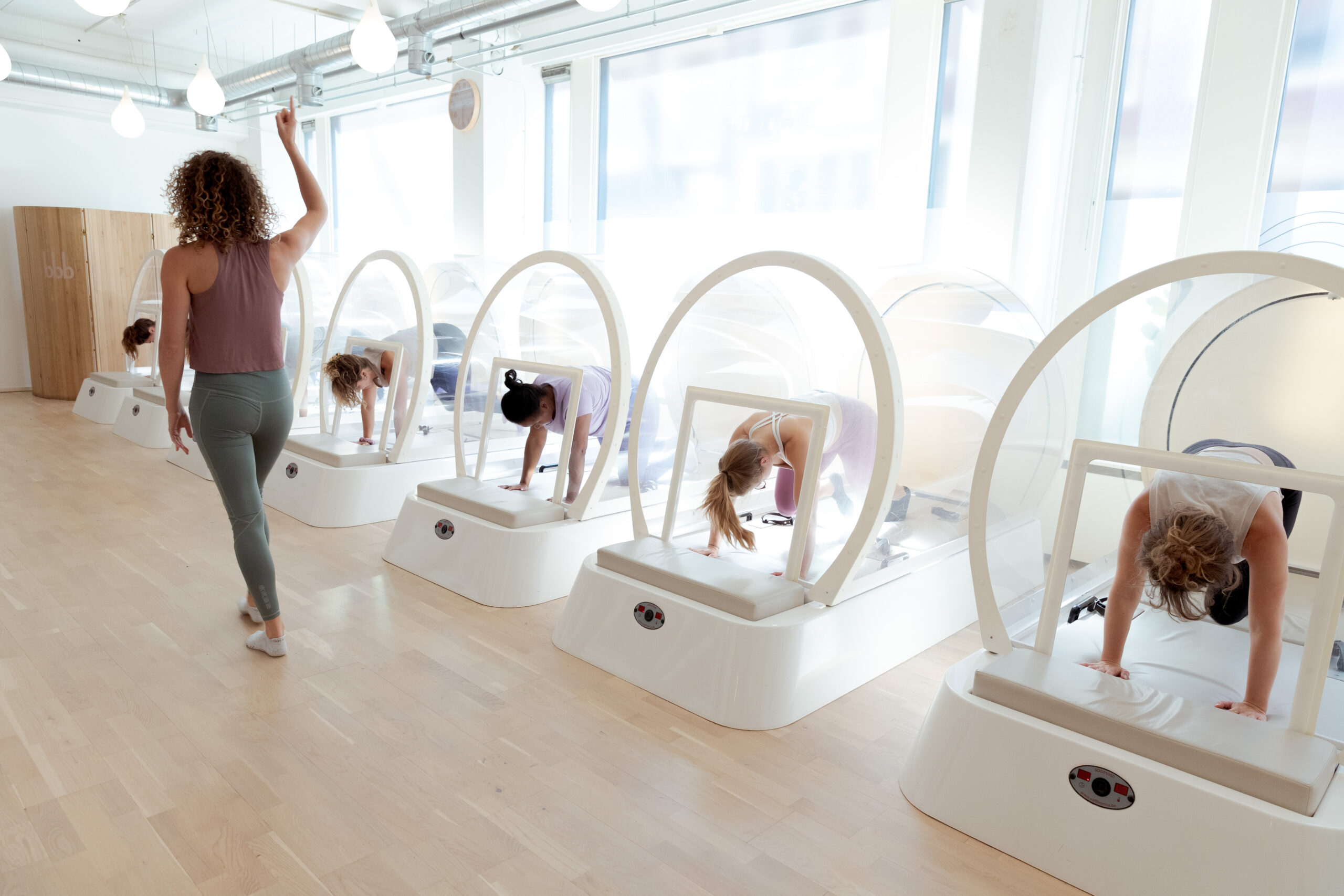 Group of women exercising together in the heat cabin at bbb health boutique.