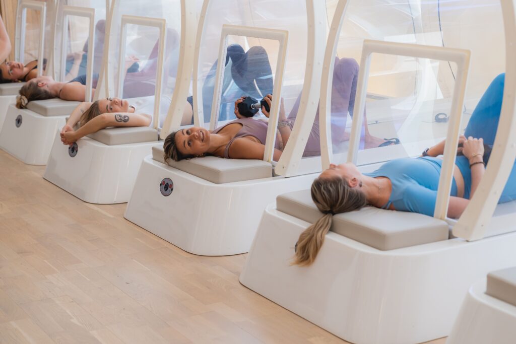 Group of women exercising together in the heat cabin at bbb health boutique.