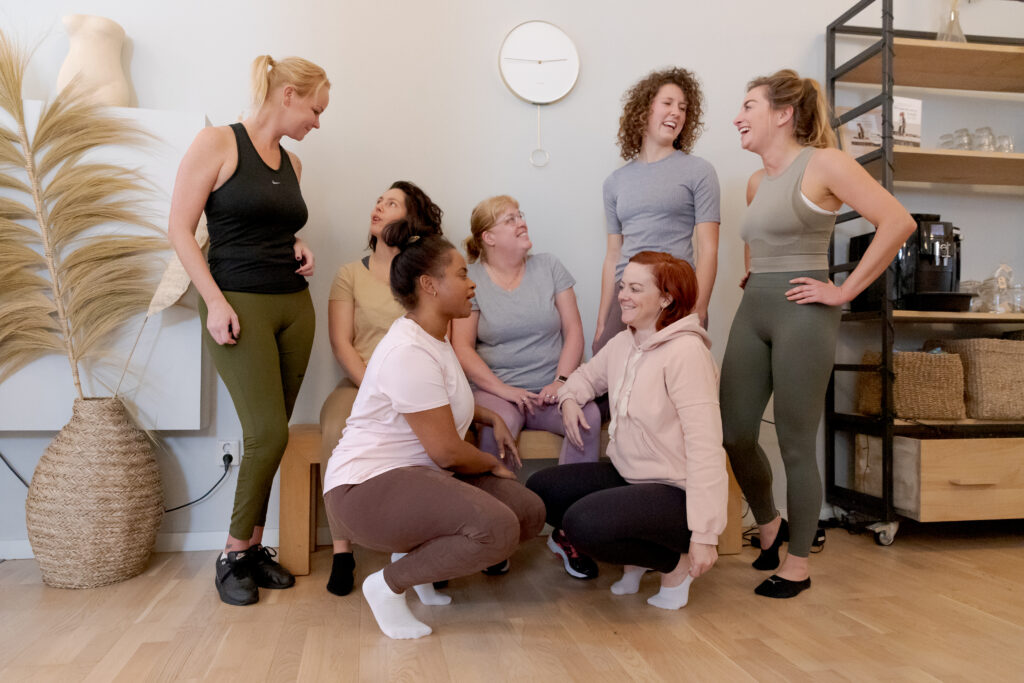 A diverse group of women talking at bbb health boutique. The women's gym for body, food, and mind.