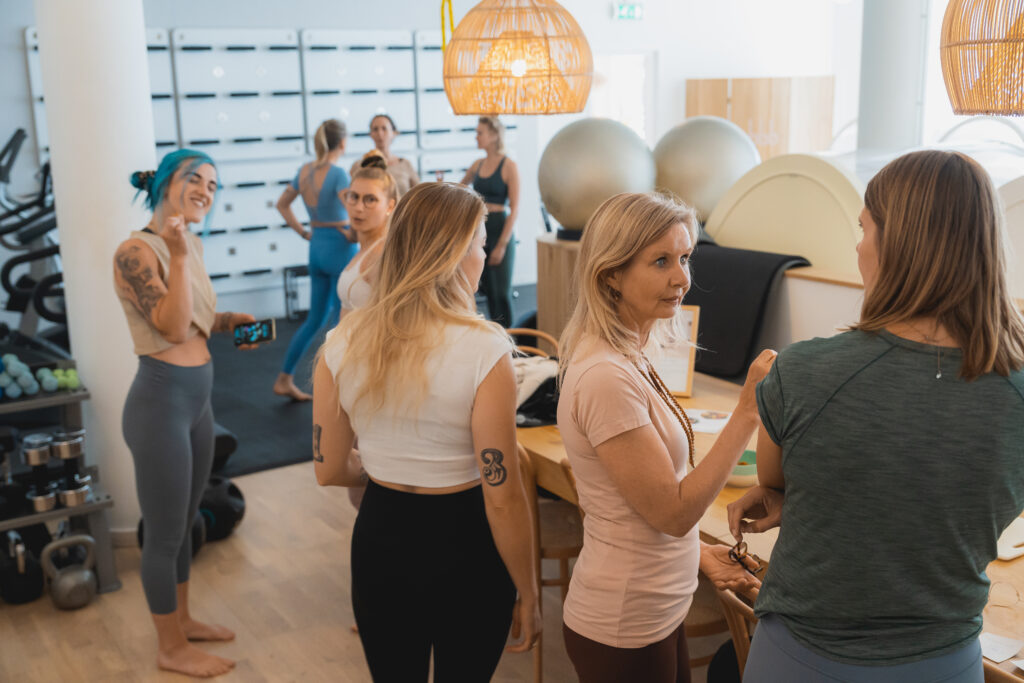 A diverse group of women talking at bbb health boutique. The women's gym for body, food, and mind.